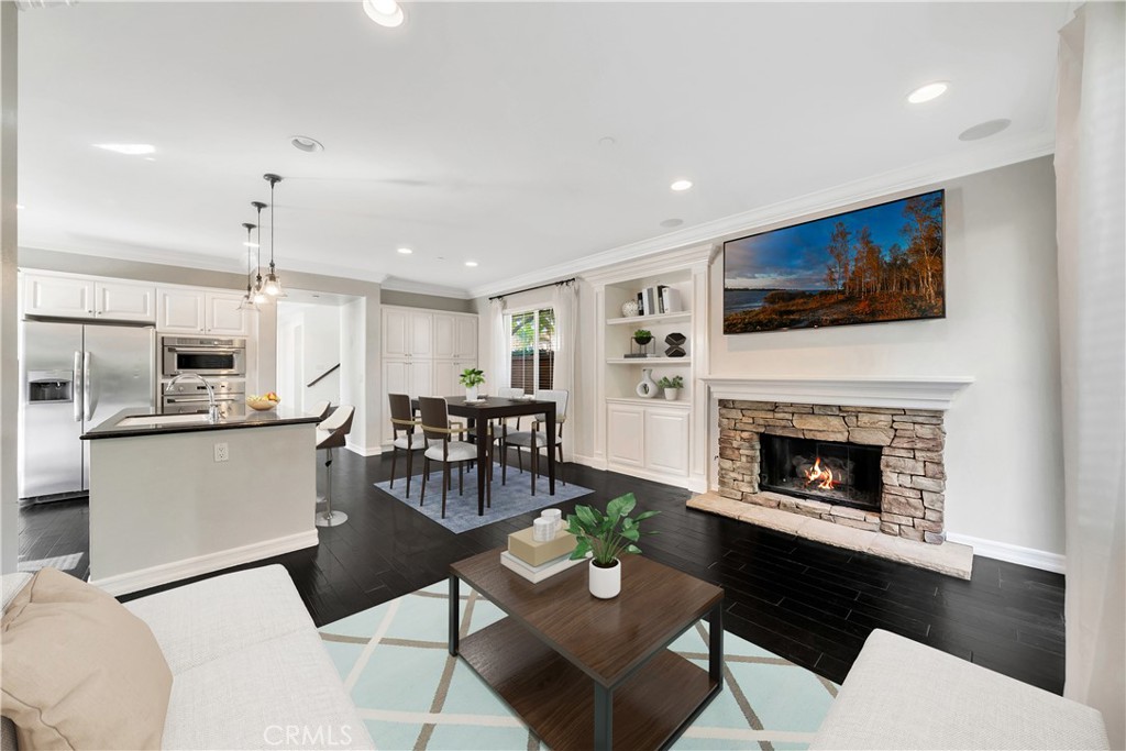 1 Via Santander San Clemente, CA 92673 - Photo 11 of 48 a living room with furniture a fireplace and a flat screen tv
