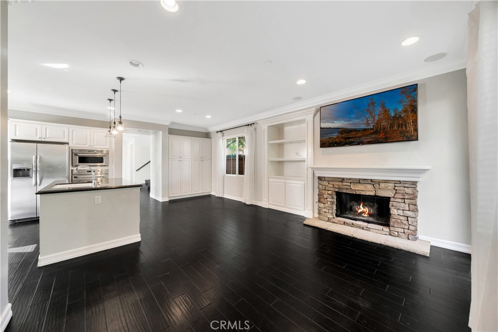 1 Via Santander San Clemente, CA 92673 - Photo 12 of 48 a living room with stainless steel appliances kitchen island hard wood floors and fireplace