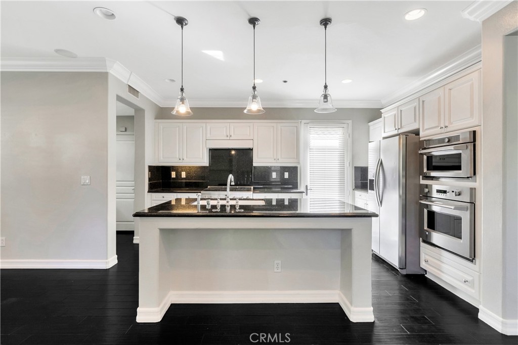 1 Via Santander San Clemente, CA 92673 - Photo 14 of 48 a kitchen with kitchen island a sink stainless steel appliances and cabinets
