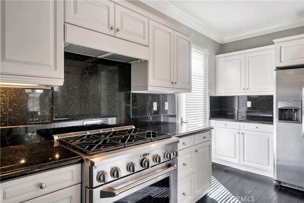 1 Via Santander San Clemente, CA 92673 - Photo 16 of 48 a kitchen with white cabinets and appliances