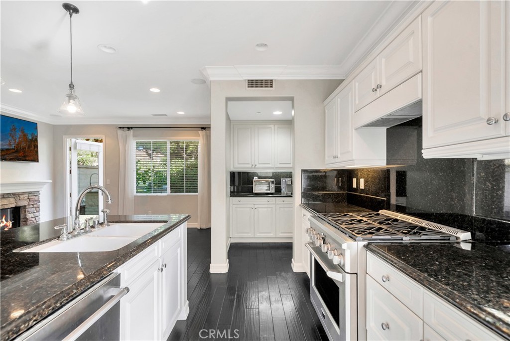 1 Via Santander San Clemente, CA 92673 - Photo 20 of 48 a kitchen with a sink stove and cabinets