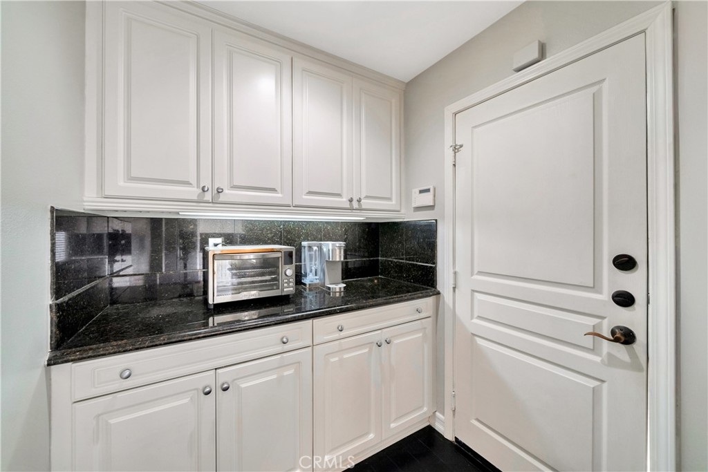 1 Via Santander San Clemente, CA 92673 - Photo 21 of 48 a kitchen with granite countertop white cabinets and a sink