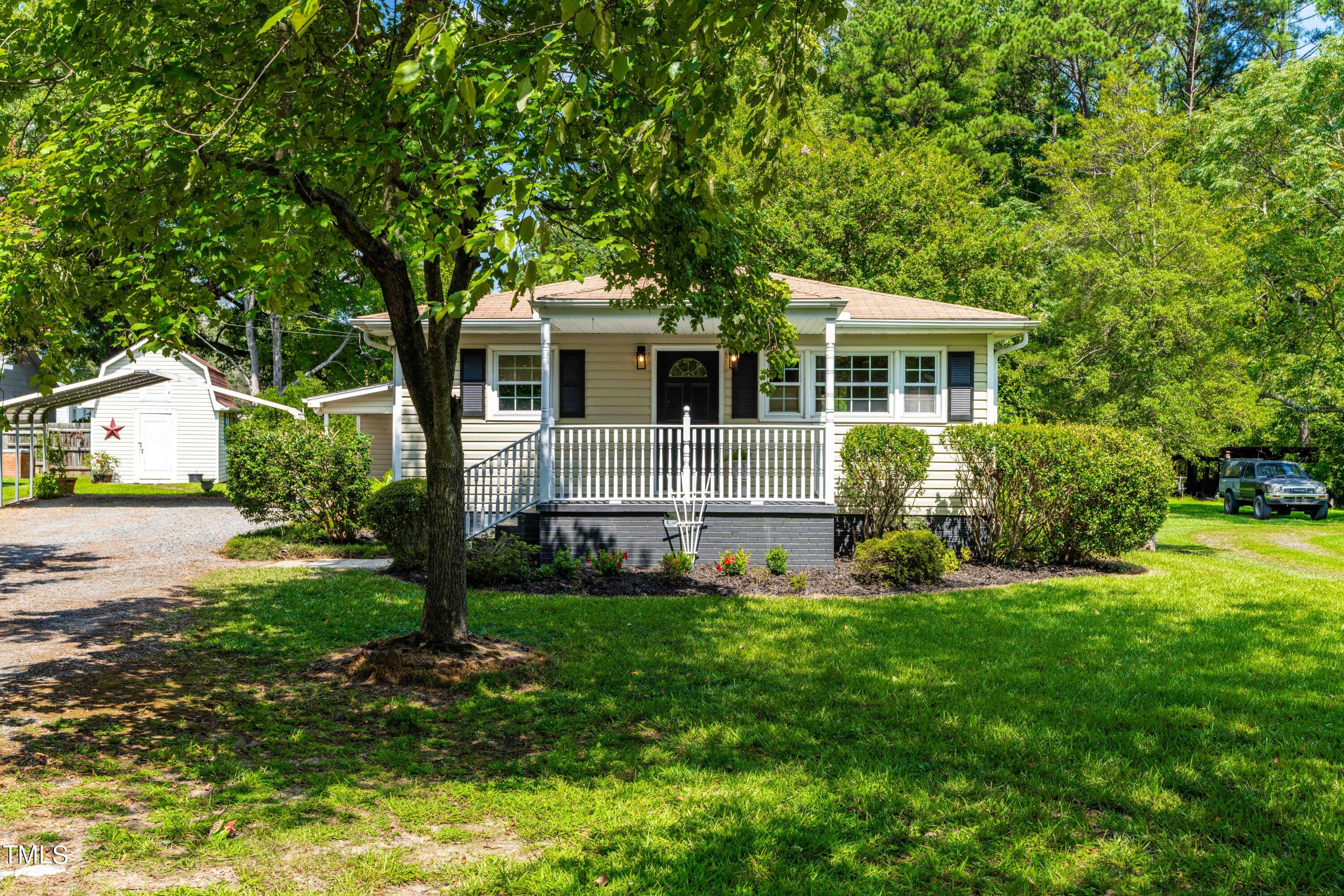 2616 Bullock Road Durham, NC 27704 - Photo 1 of 41 a front view of a house with a garden and yard