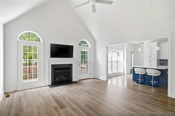 a view of an empty room with a fireplace and a window