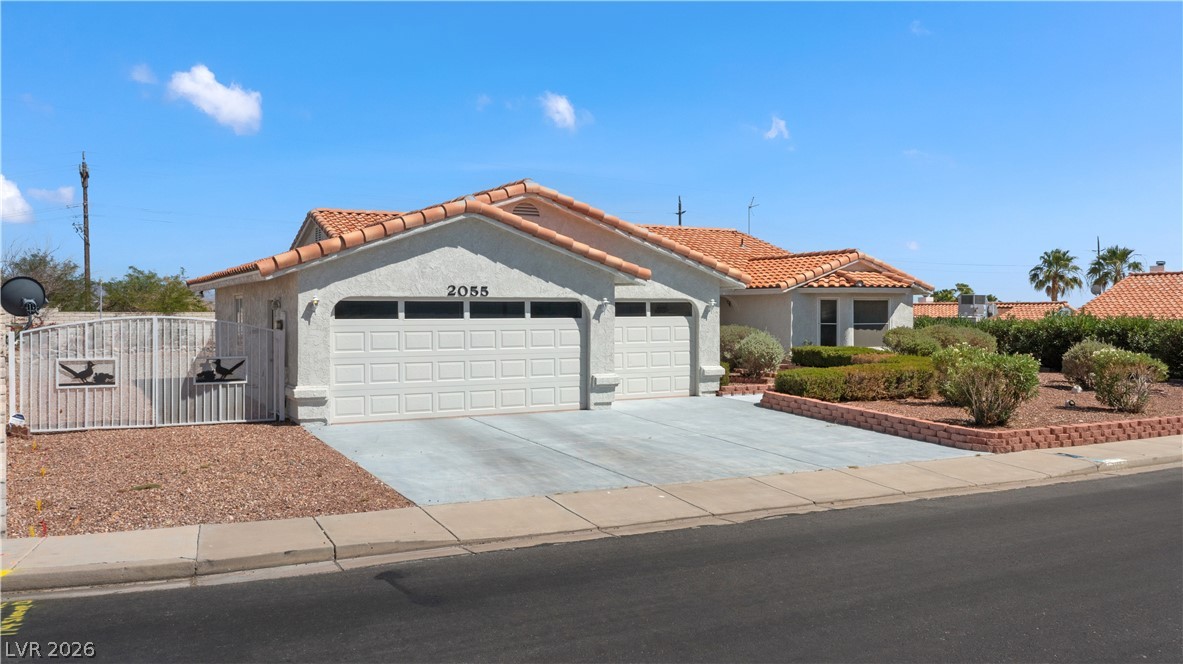 2055 Cholla Way Laughlin, NV 89029 - Photo 66 of 87 Two-car garage and low-maintenance landscaping welcome you to this charming single-story residence.