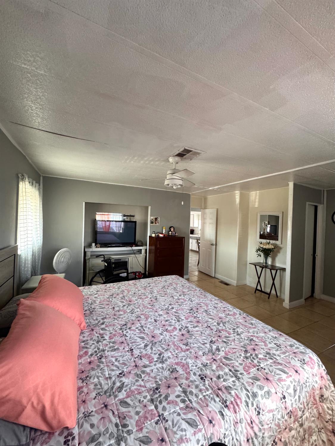 436 North Mercey Springs Road, Unit 154 Los Banos, CA 93635 - Photo 14 of 23 a large bedroom with a bed and a flat screen tv