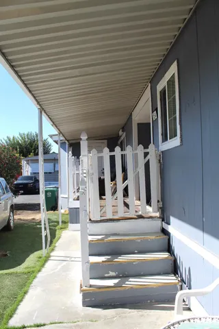 a view of house with entryway and stairs