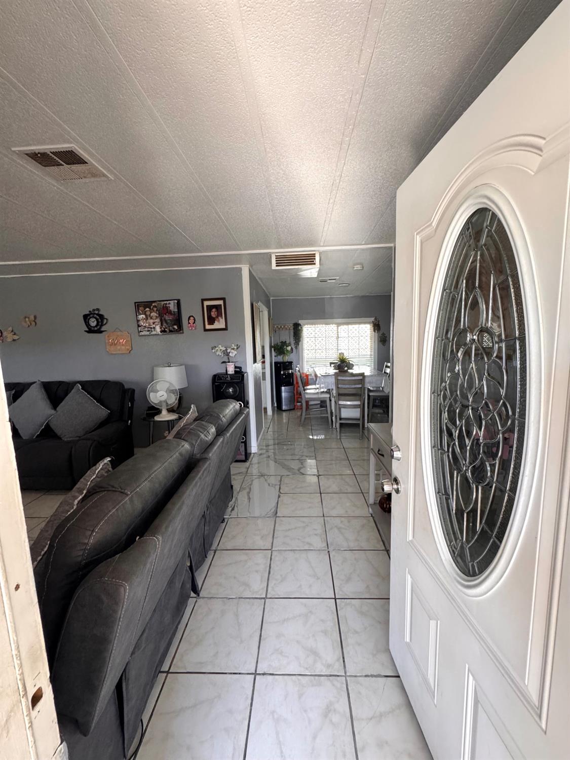 436 North Mercey Springs Road, Unit 154 Los Banos, CA 93635 - Photo 6 of 23 a hallway with a washer and dryer