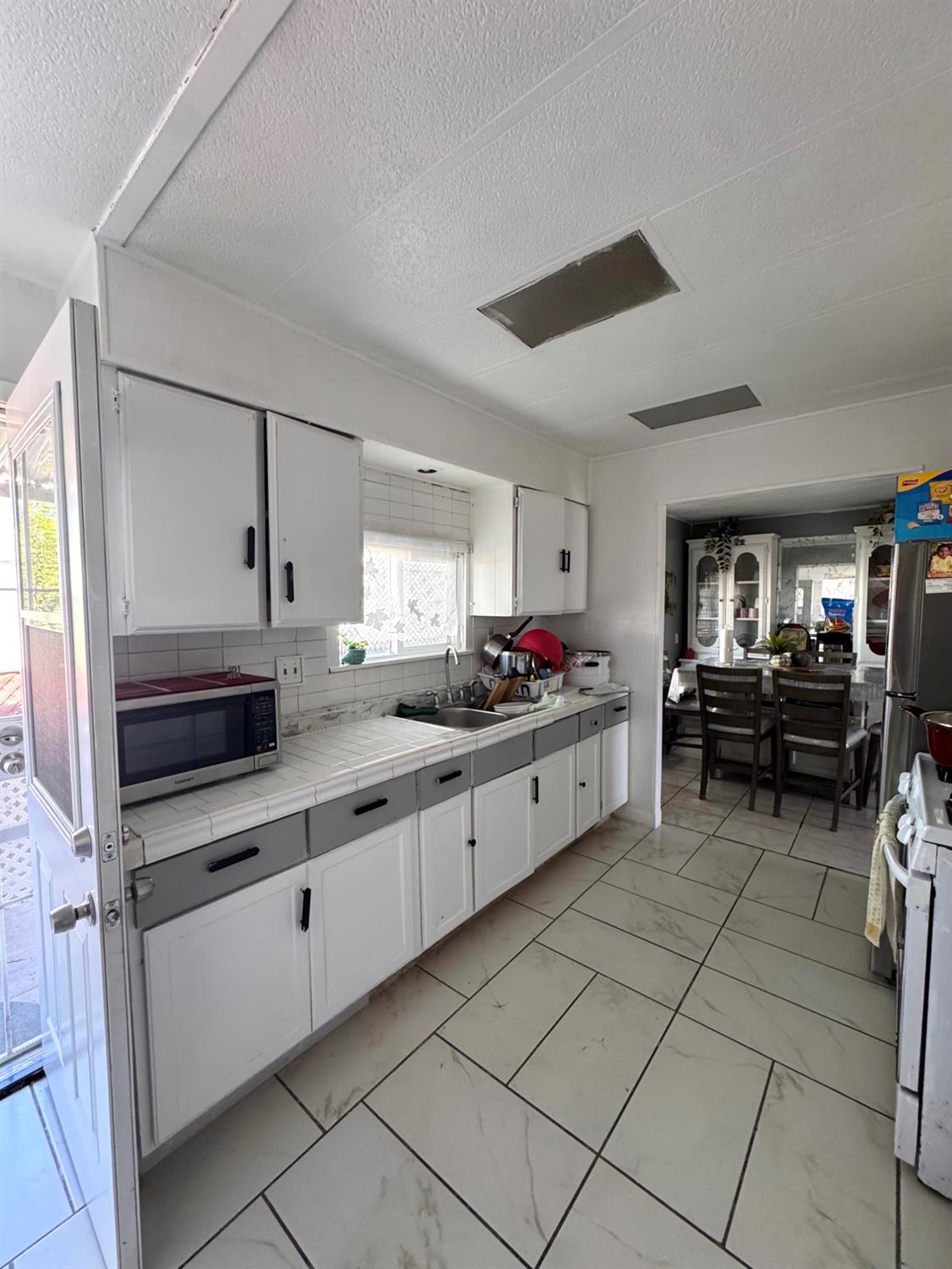 436 North Mercey Springs Road, Unit 154 Los Banos, CA 93635 - Photo 8 of 23 a kitchen with granite countertop a sink cabinets and counter space