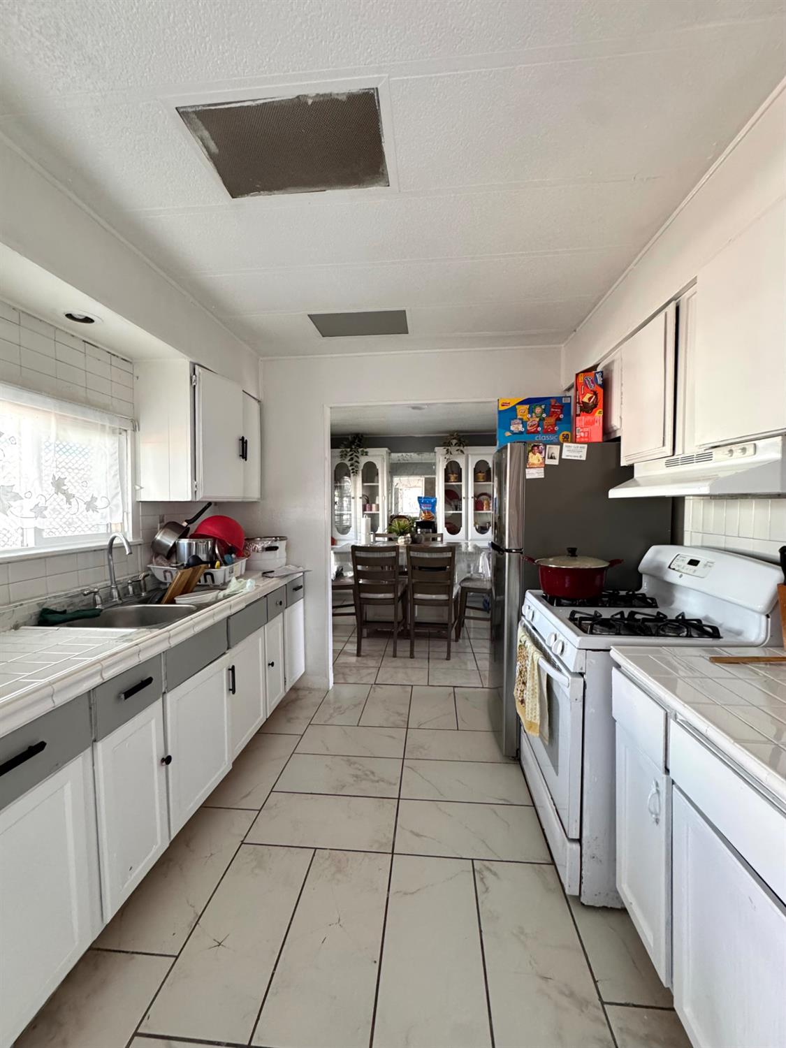 436 North Mercey Springs Road, Unit 154 Los Banos, CA 93635 - Photo 9 of 23 a kitchen with kitchen island granite countertop a sink counter top space appliances and cabinets