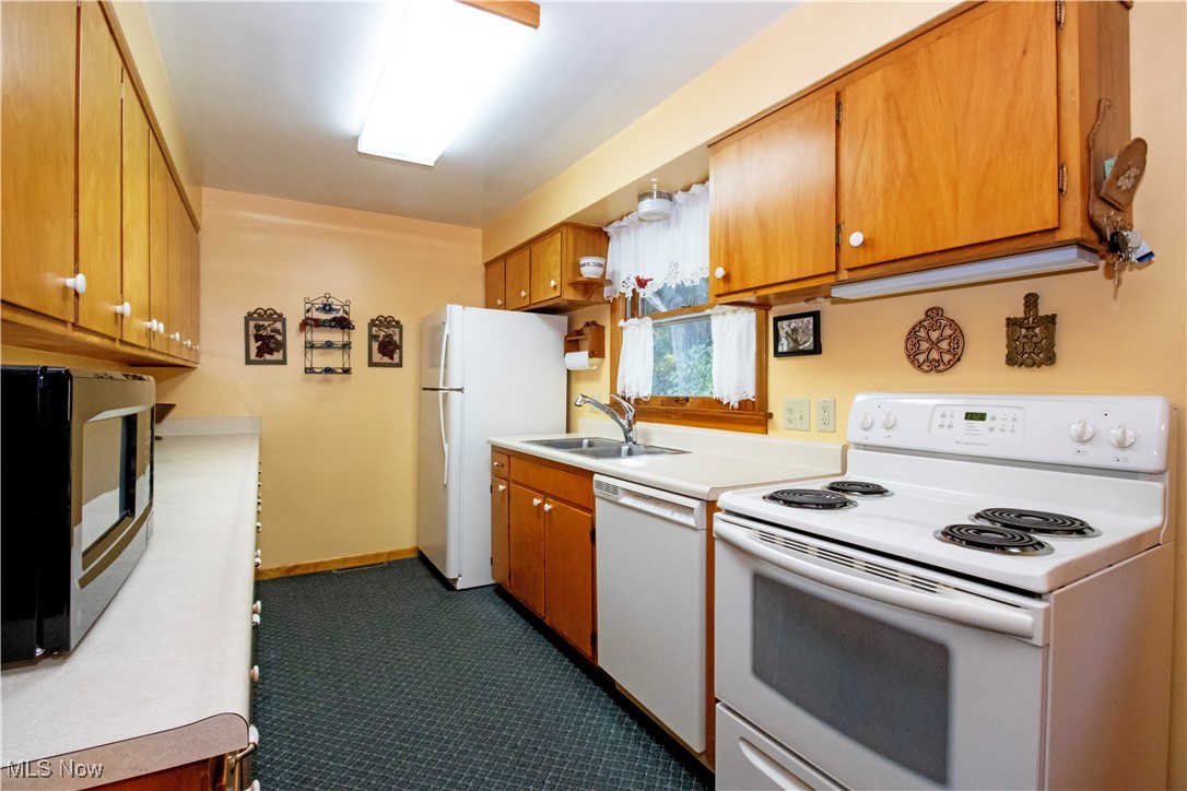 912 Ridgecrest Drive Wooster, OH 44691 - Photo 6 of 27 Kitchen featuring sink and white appliances