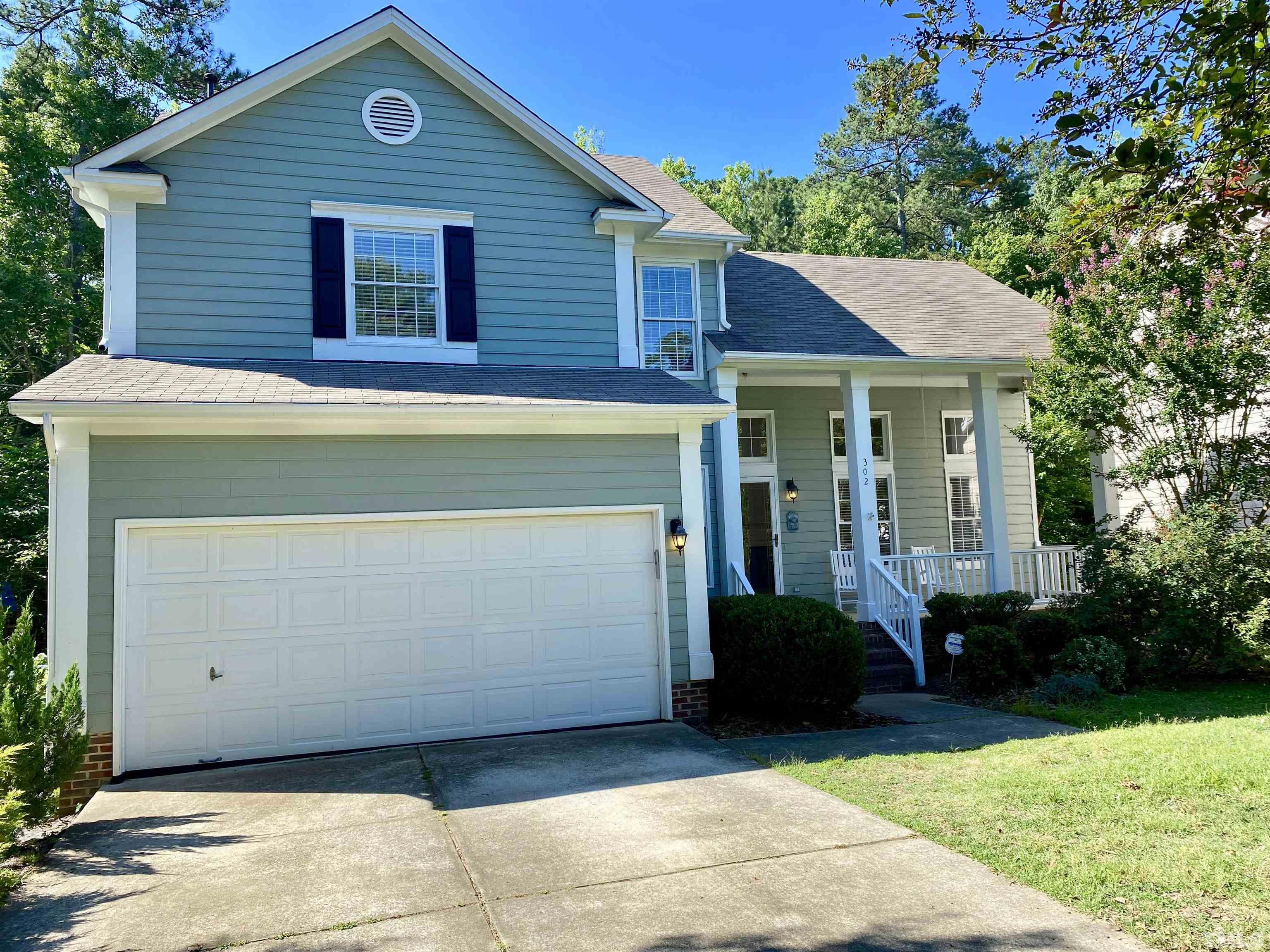 302 Bebington Drive Cary, NC 27513 - Photo 1 of 27 a front view of a house with a yard and garage