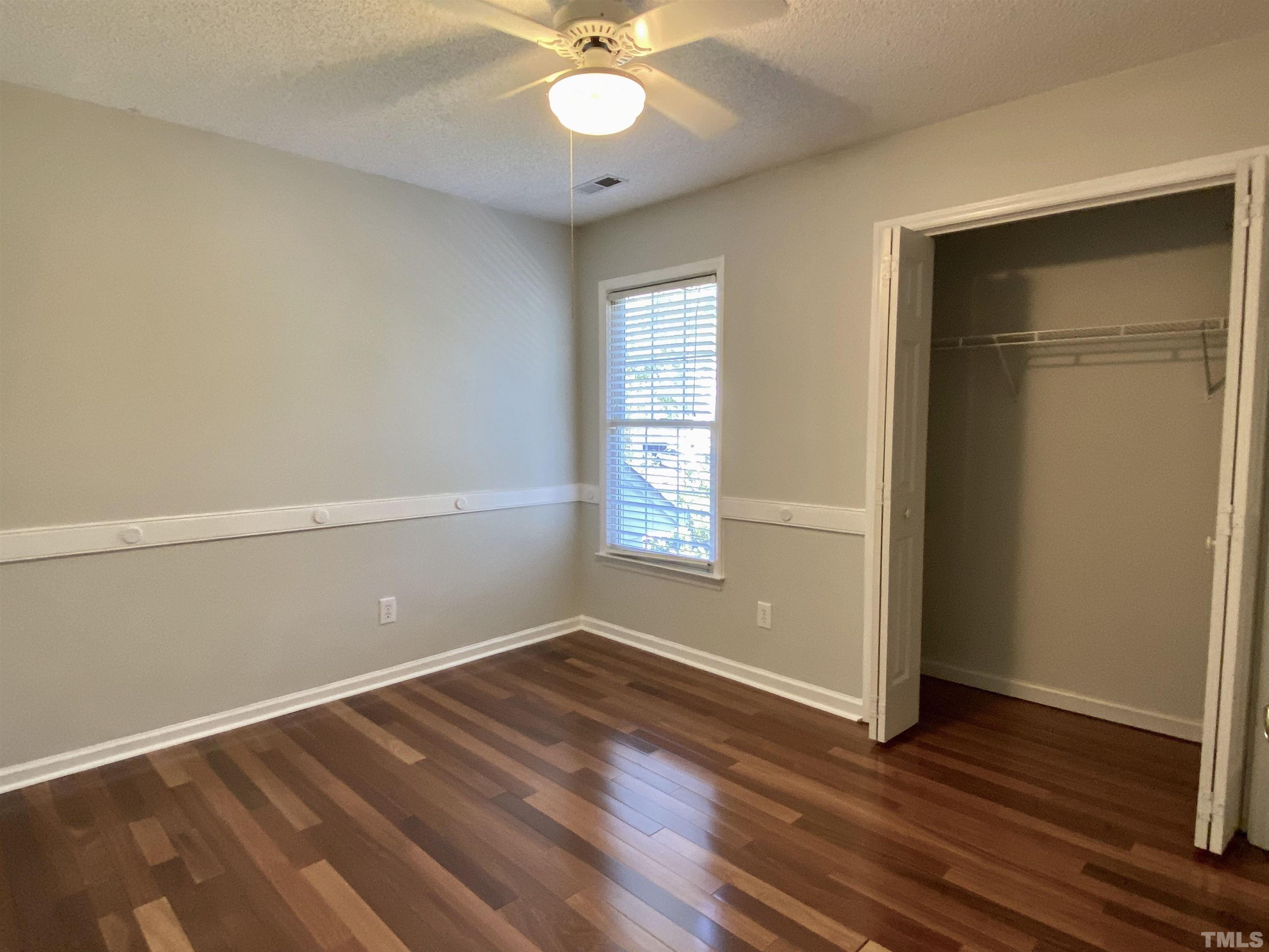 302 Bebington Drive Cary, NC 27513 - Photo 17 of 27 an empty room with wooden floor closet and windows
