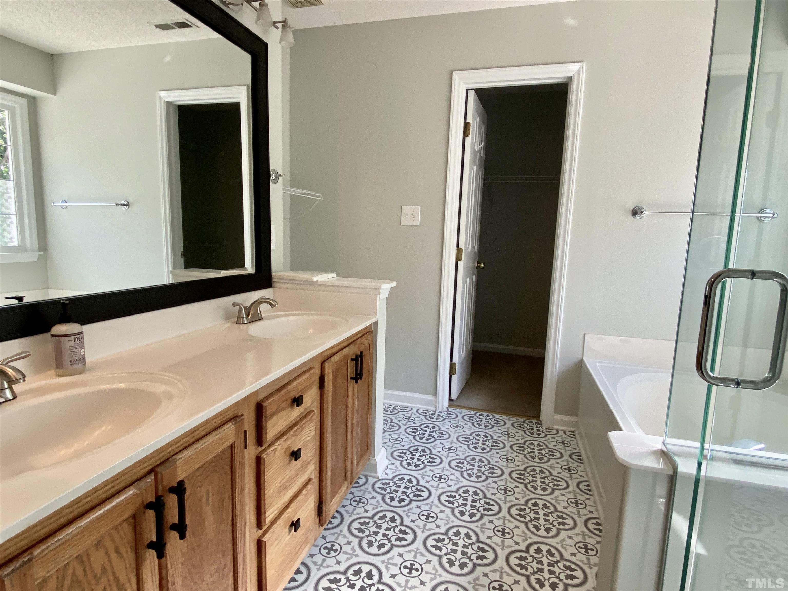 302 Bebington Drive Cary, NC 27513 - Photo 19 of 27 a bathroom with a sink and a mirror