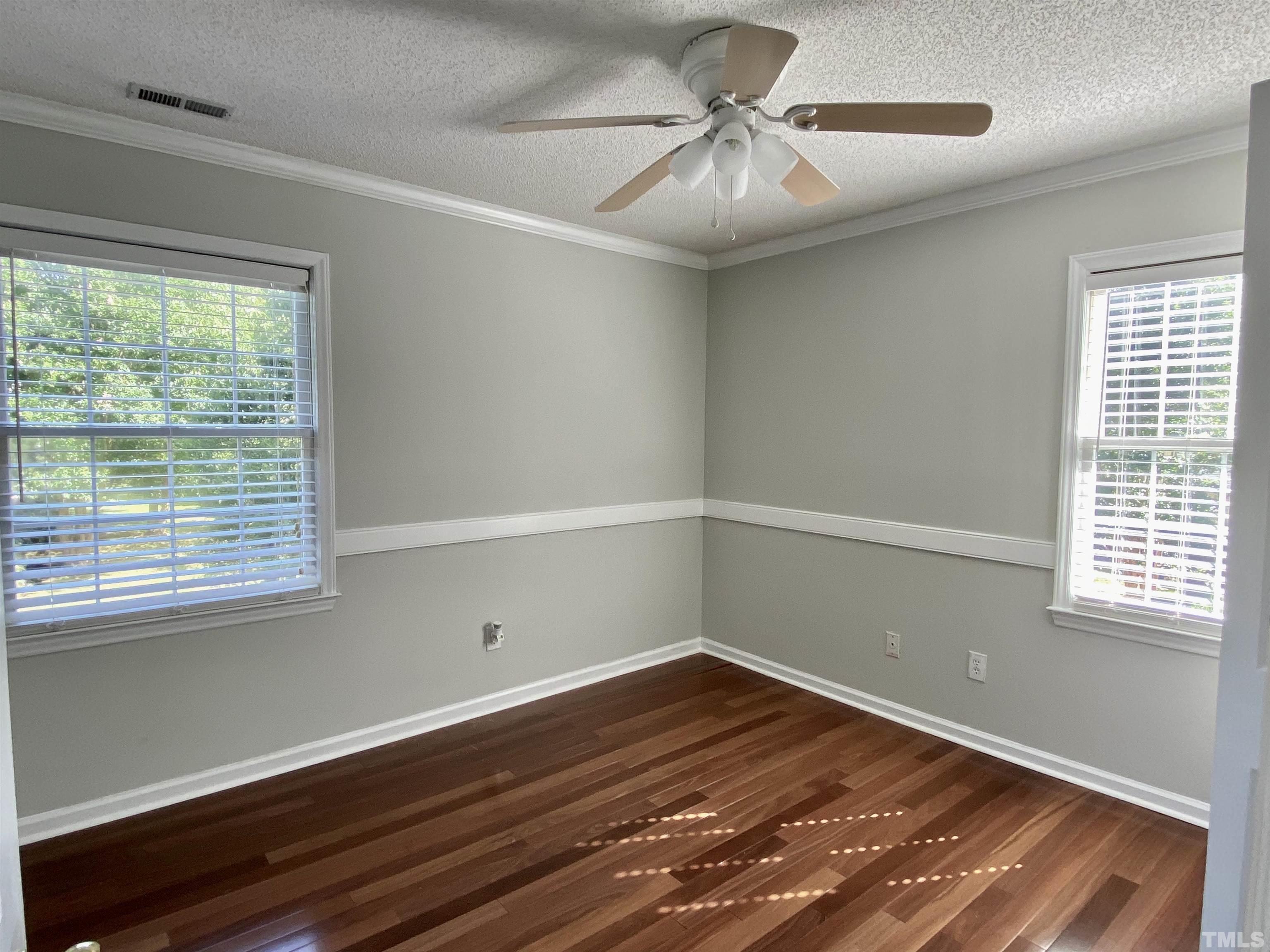 302 Bebington Drive Cary, NC 27513 - Photo 21 of 27 a view of a room with wooden floor and fan
