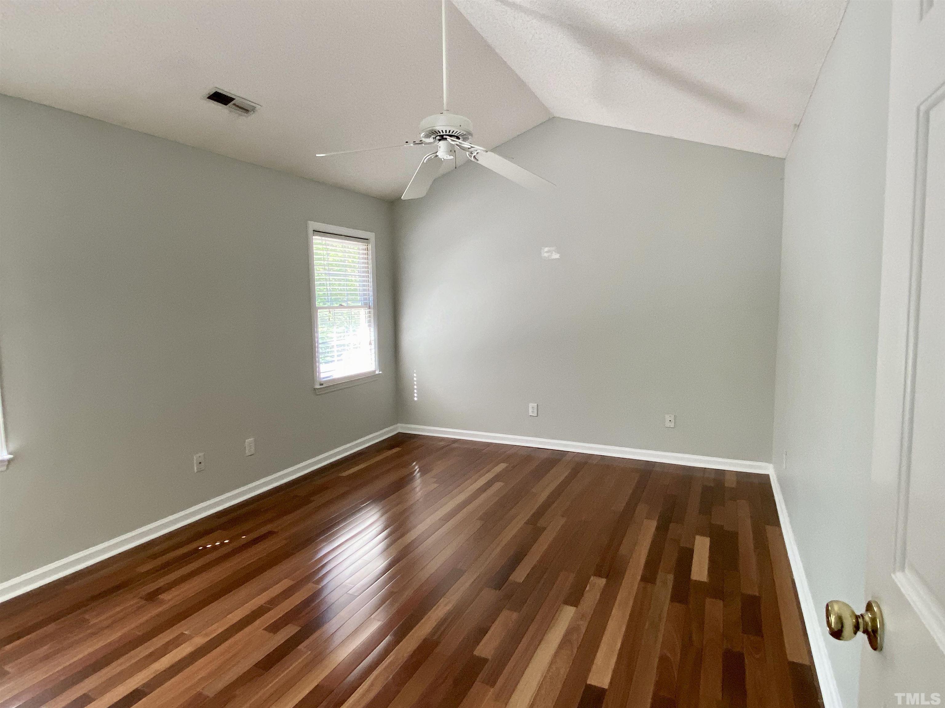 302 Bebington Drive Cary, NC 27513 - Photo 22 of 27 a view of an empty room with wooden floor and a window