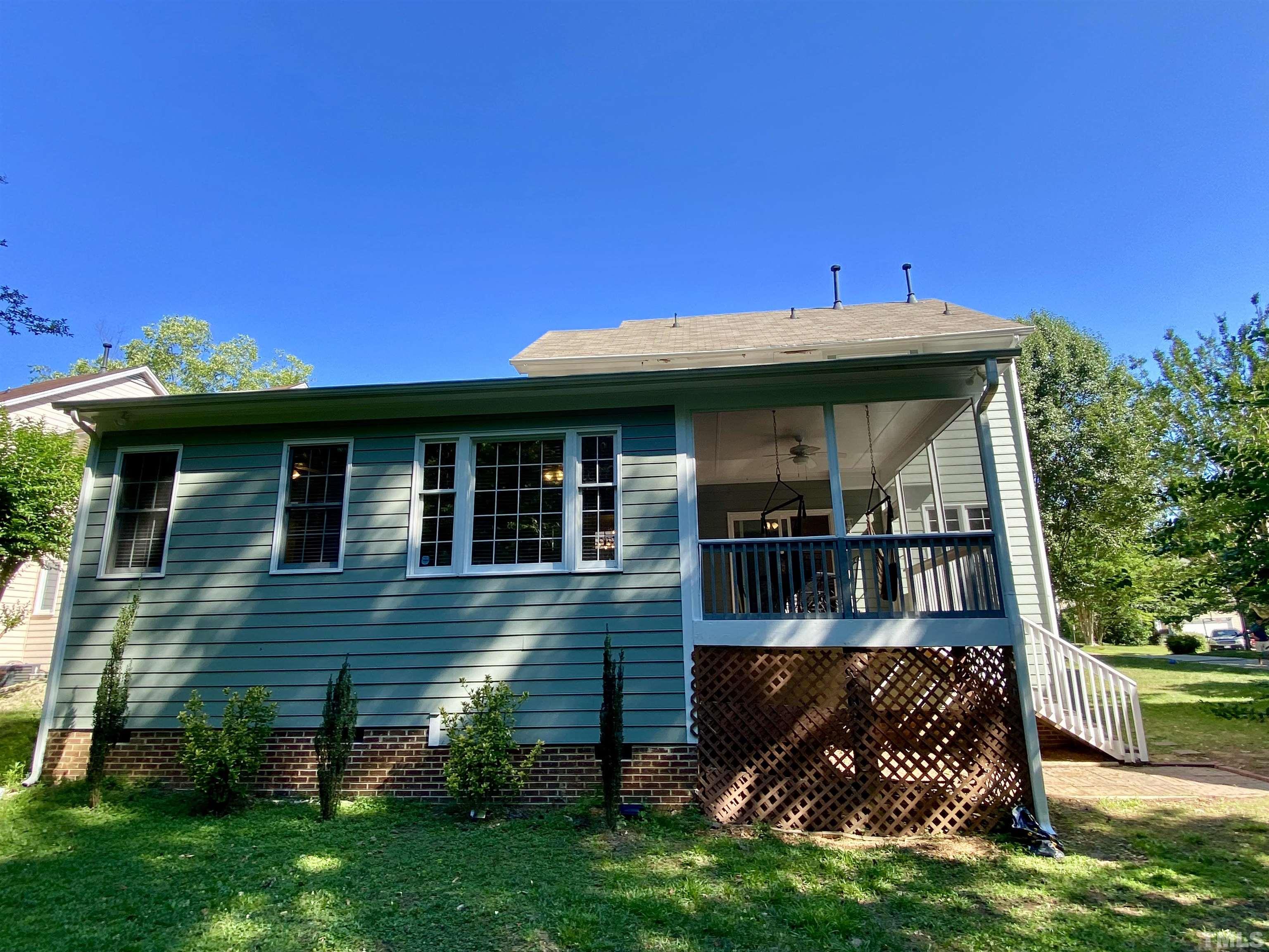302 Bebington Drive Cary, NC 27513 - Photo 26 of 27 a view of a house with a yard potted plants and a table