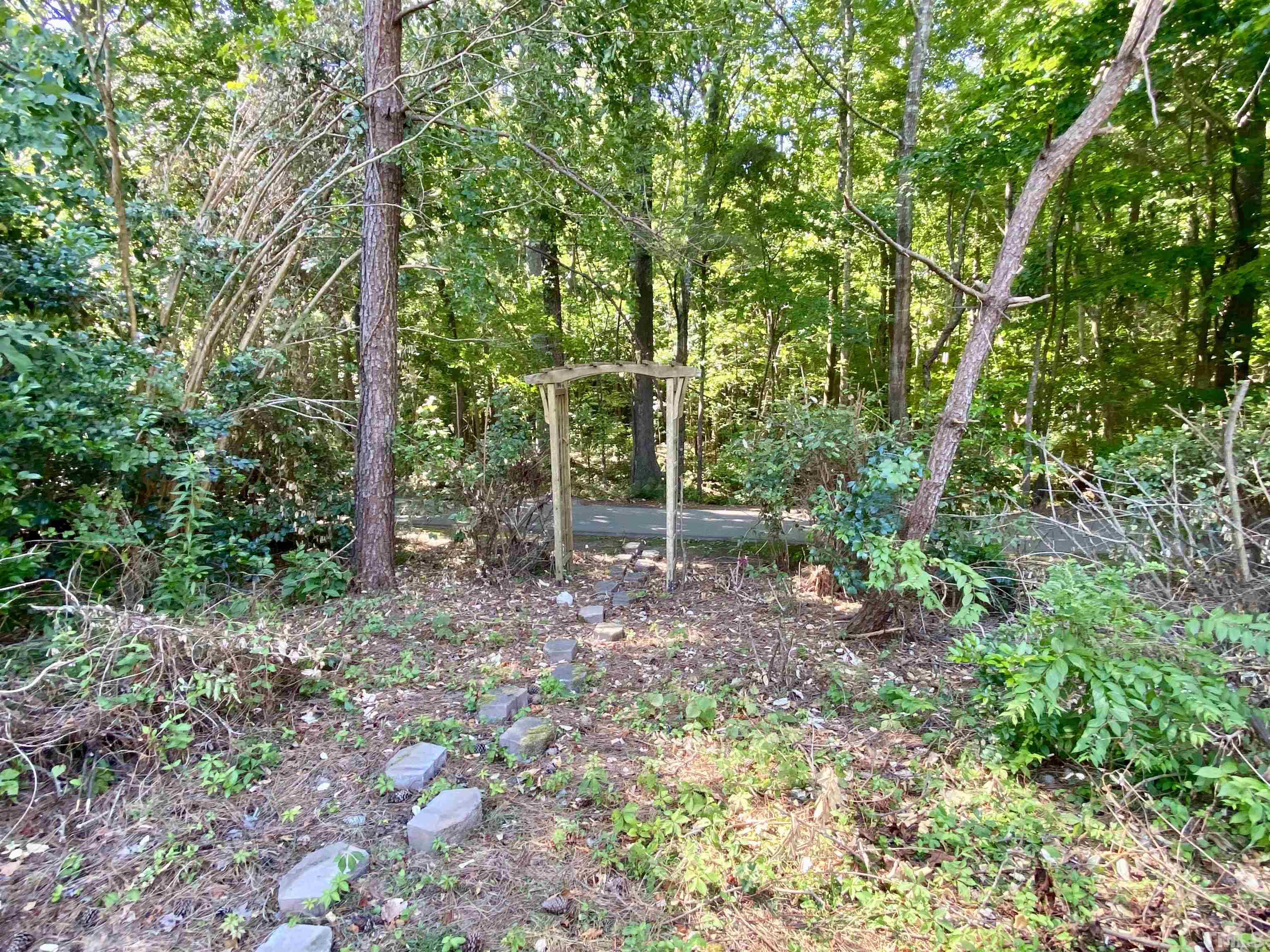 302 Bebington Drive Cary, NC 27513 - Photo 27 of 27 a backyard of a house with lots of green space and chair