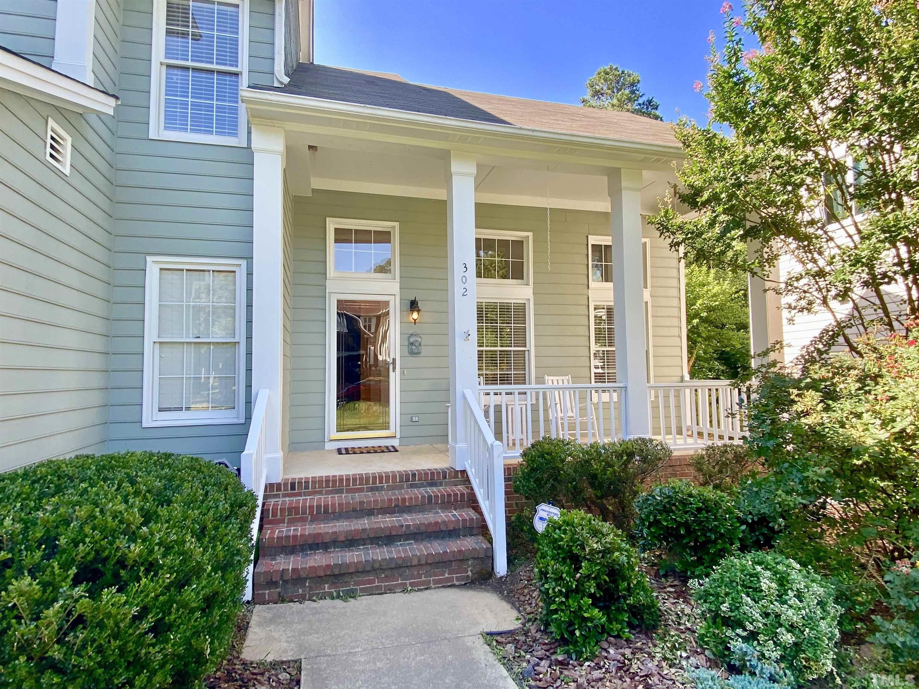302 Bebington Drive Cary, NC 27513 - Photo 3 of 27 a front view of a house with a yard