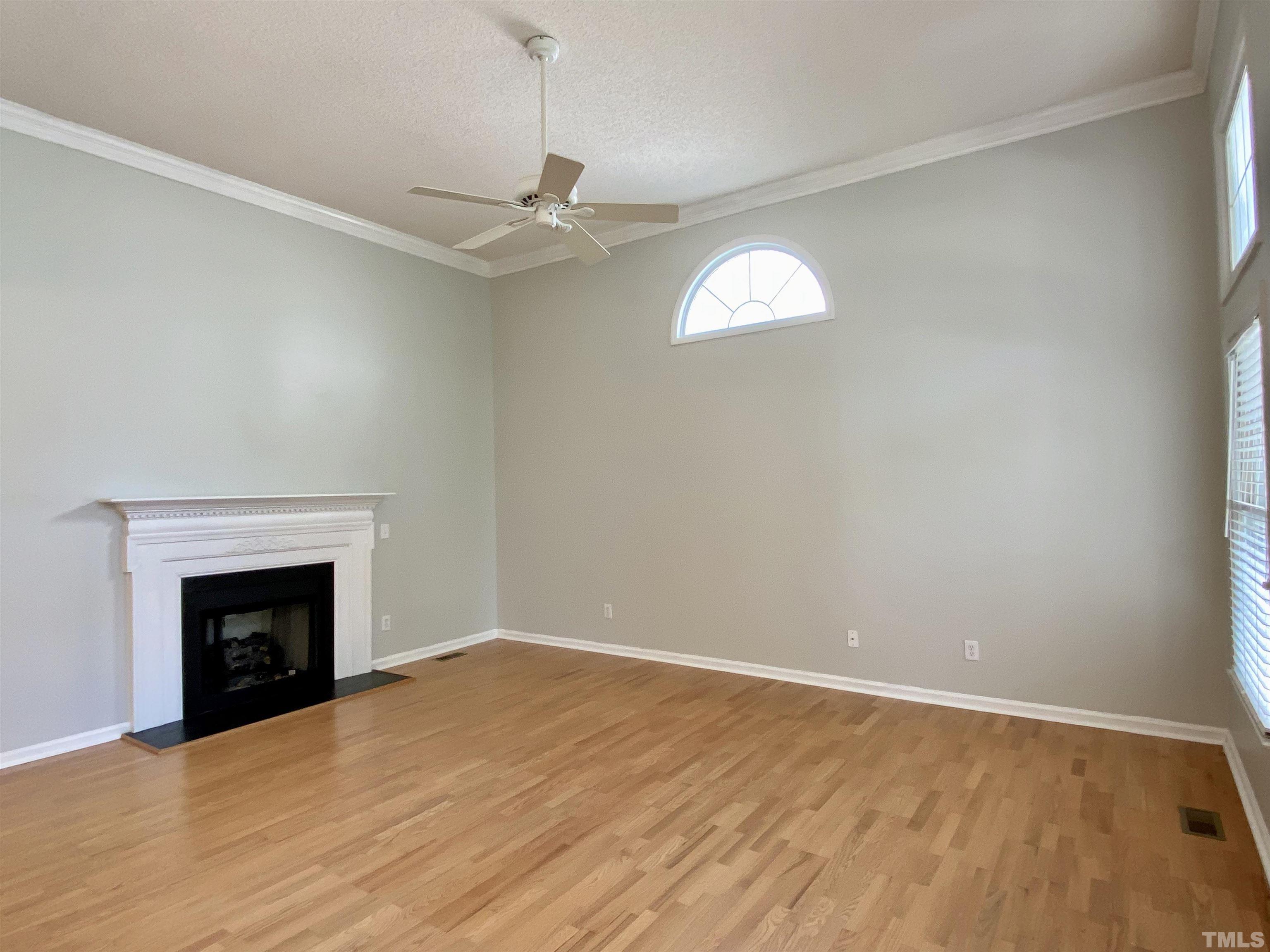 302 Bebington Drive Cary, NC 27513 - Photo 5 of 27 an empty room with windows and fireplace