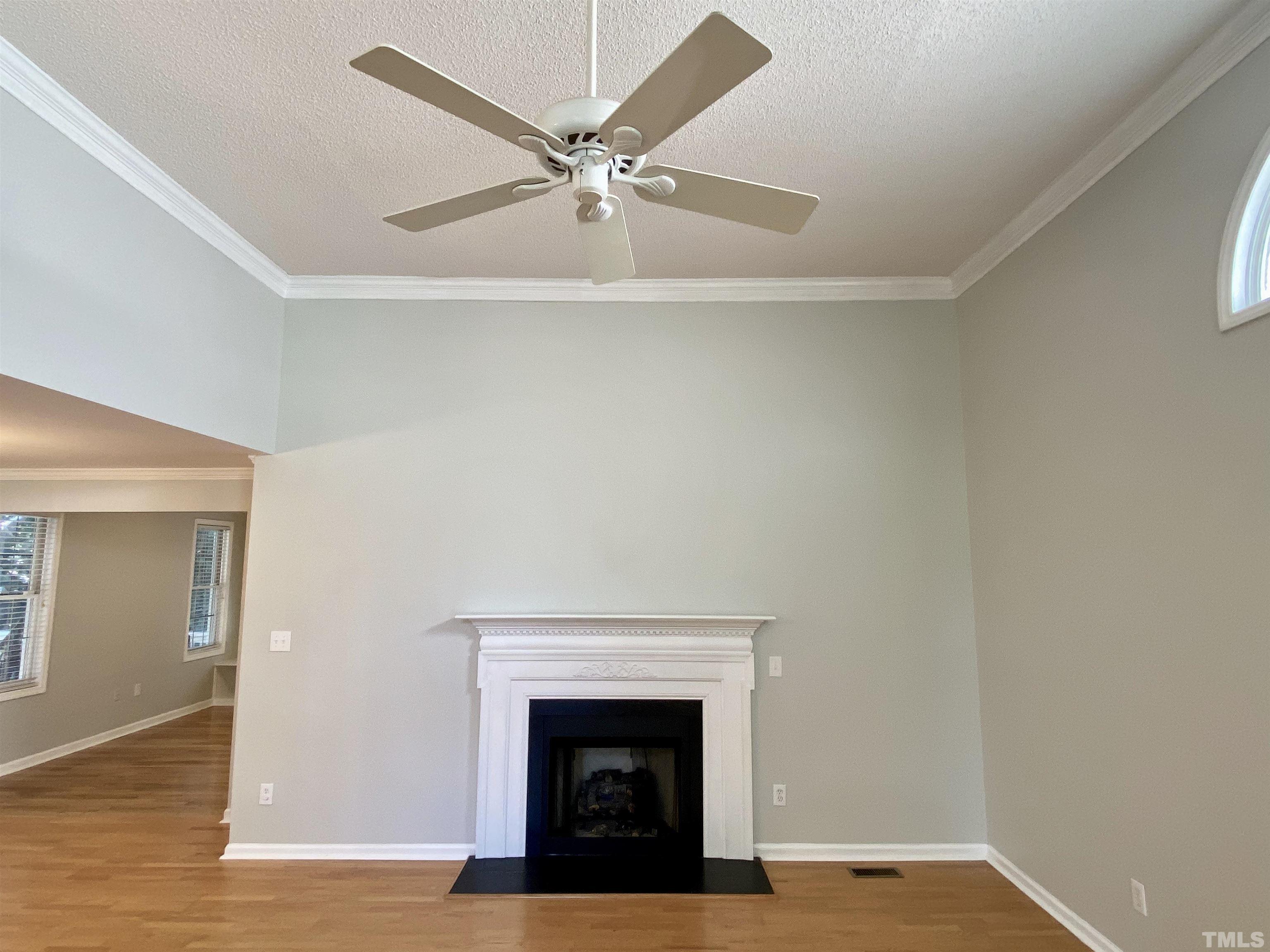 302 Bebington Drive Cary, NC 27513 - Photo 6 of 27 a view of an empty room with window and wooden floor
