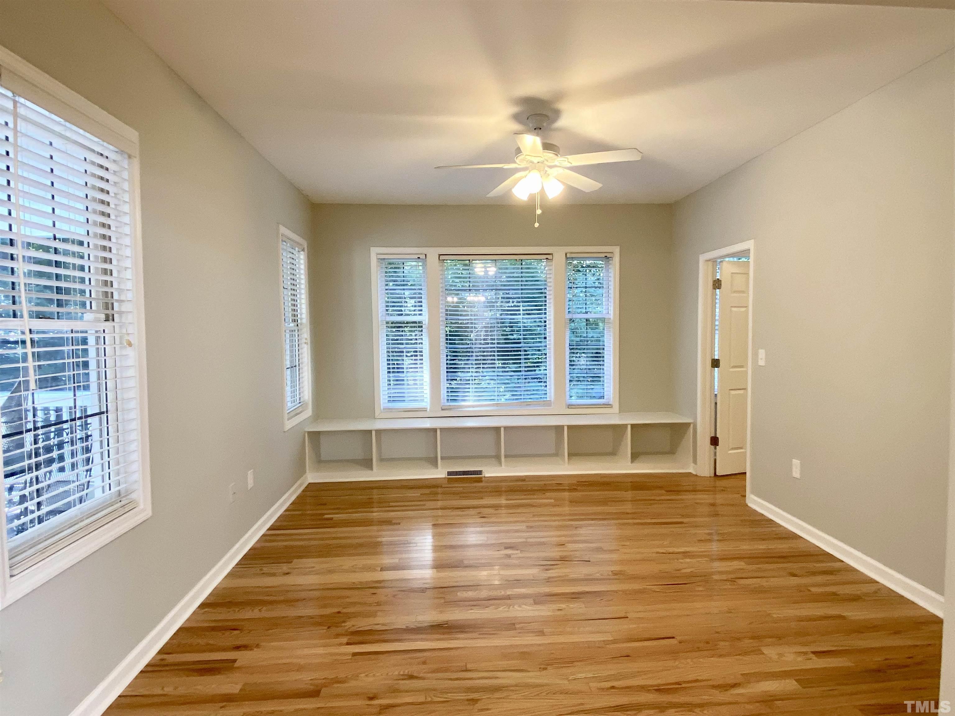 302 Bebington Drive Cary, NC 27513 - Photo 8 of 27 an empty room with wooden floor and windows