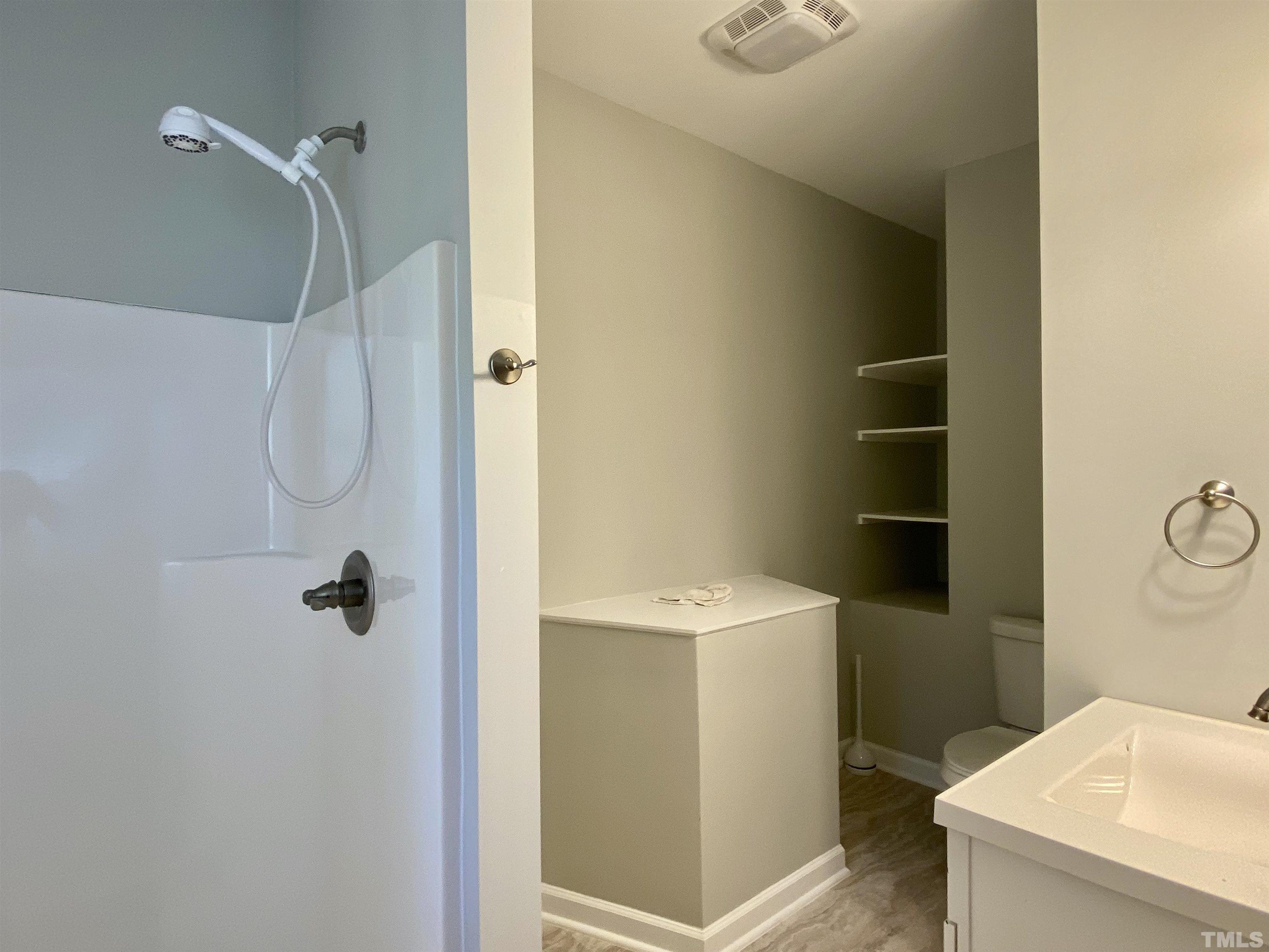 302 Bebington Drive Cary, NC 27513 - Photo 10 of 27 a bathroom with a granite countertop shower and a sink
