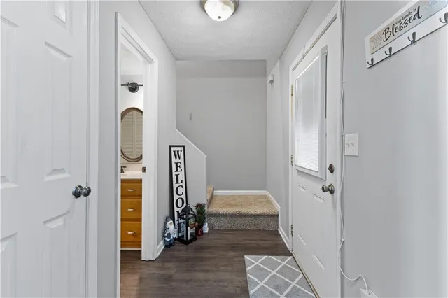 a view of a hallway with a livingroom and closet