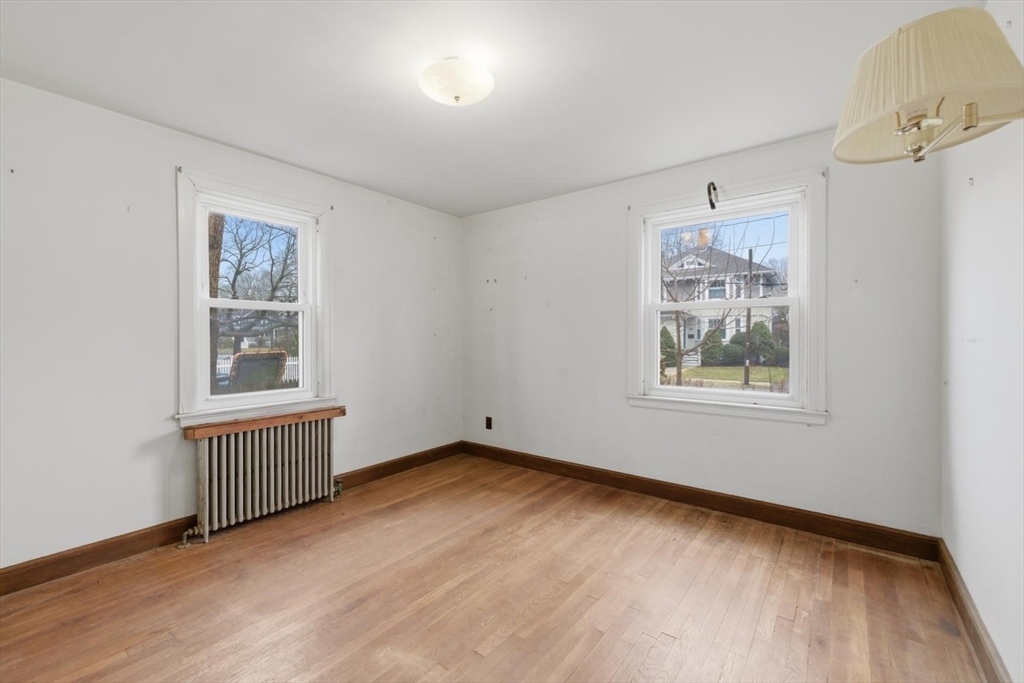 11 Clark Avenue Walpole, MA 02081 - Photo 15 of 25 a view of an empty room with a window and wooden floor
