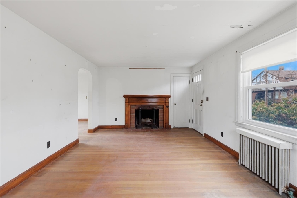 11 Clark Avenue Walpole, MA 02081 - Photo 8 of 25 a view of an empty room with a fireplace and a window