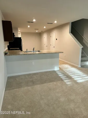 a view of kitchen with flat screen tv and refrigerator