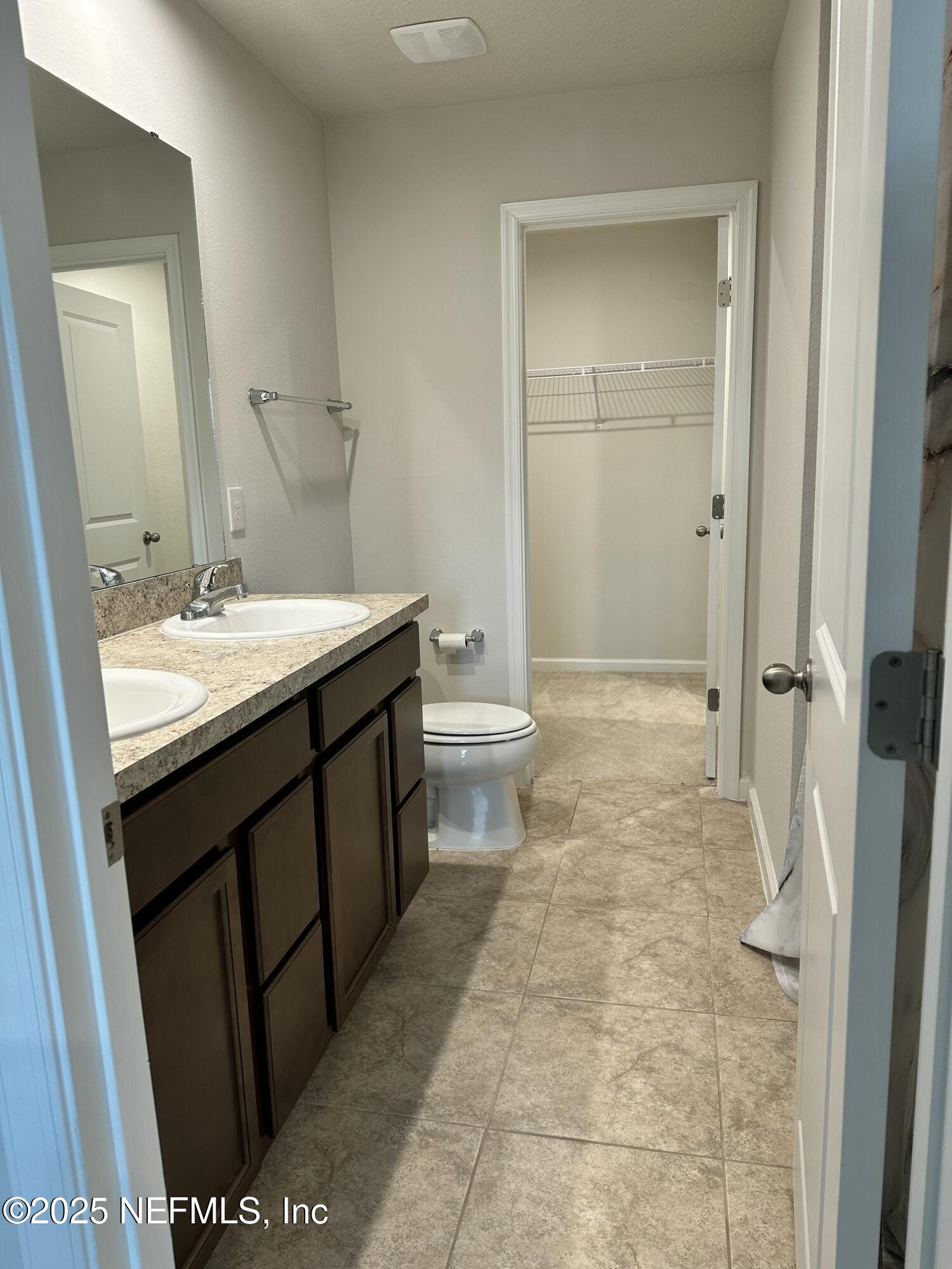 2548 Sadler Trce Way Jacksonville, FL 32210 - Photo 4 of 12 a bathroom with a sink a toilet and shower