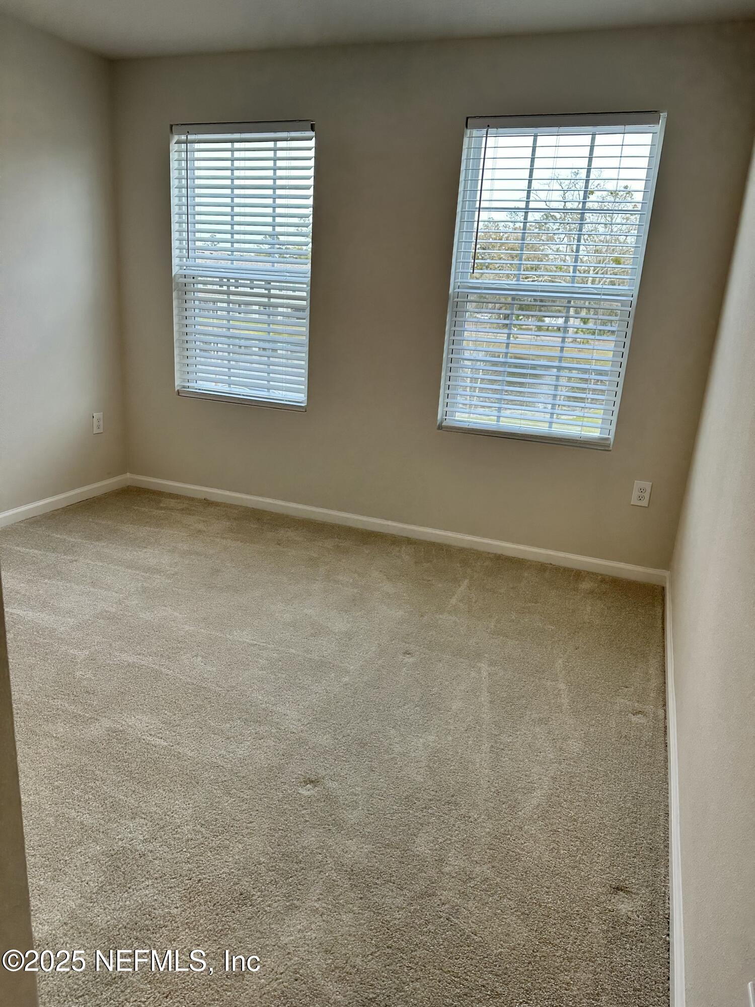 2548 Sadler Trce Way Jacksonville, FL 32210 - Photo 7 of 12 an empty room with windows