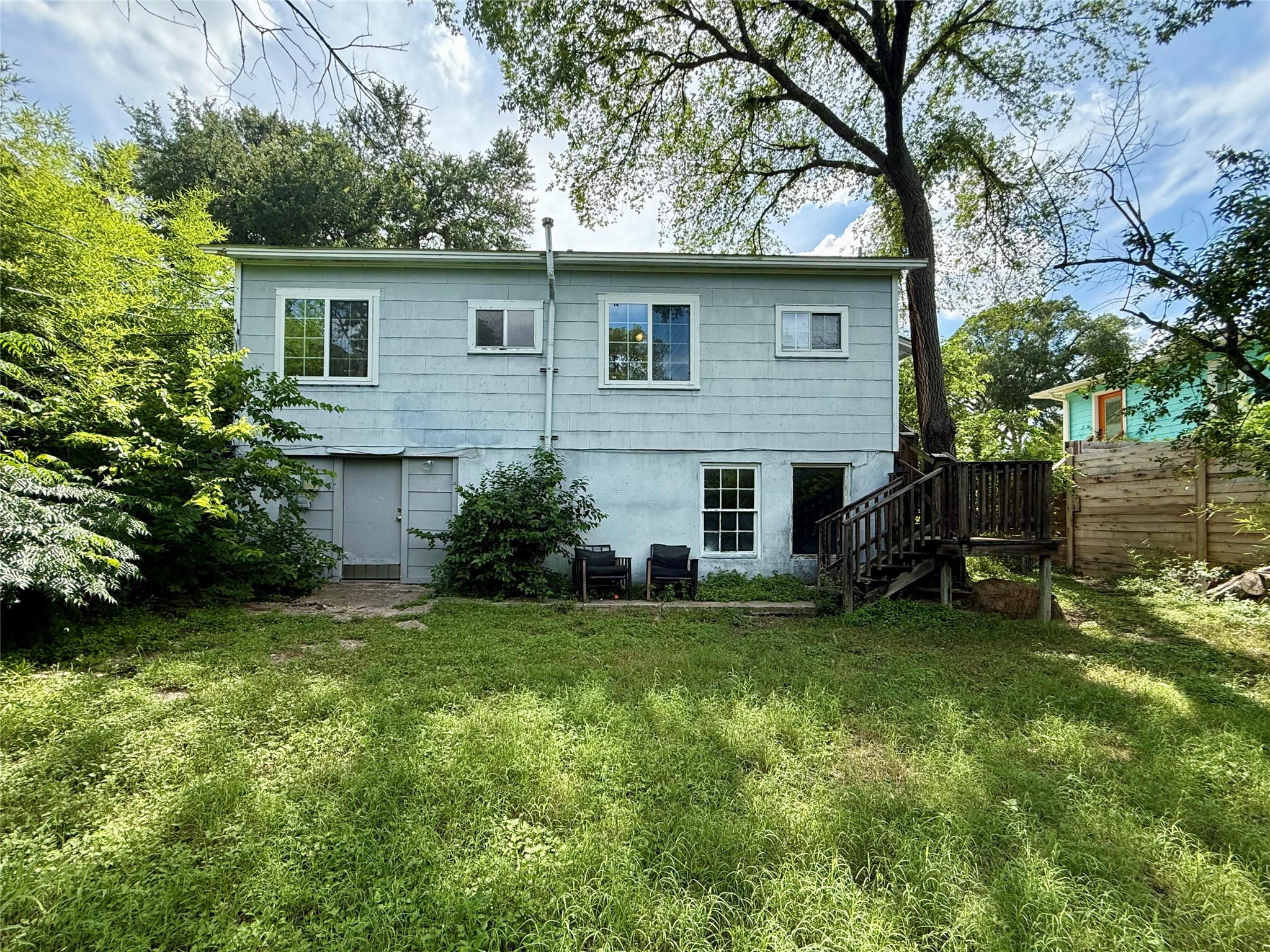 3305 Merrie Lynn Avenue Austin, TX 78722 - Photo 19 of 22 A modest rear exterior provides direct access to the generous backyard.