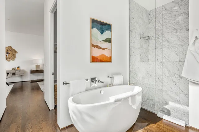 a white bath tub sitting next to a bathroom sink
