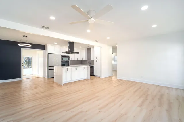 a spacious bathroom with a shower sink and mirror