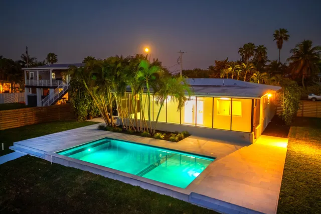 a kitchen with stainless steel appliances granite countertop a stove oven and a wooden floors
