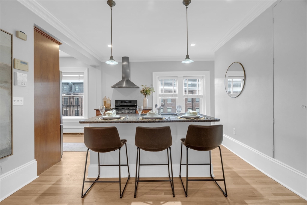 69 Rutland Street, Unit 3 Boston, MA 02118 - Photo 16 of 39 a kitchen with a dining table a sink and cabinets