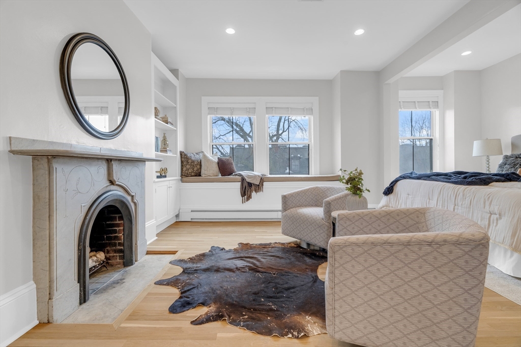 69 Rutland Street, Unit 3 Boston, MA 02118 - Photo 21 of 39 a living room with furniture a large mirror and a fireplace