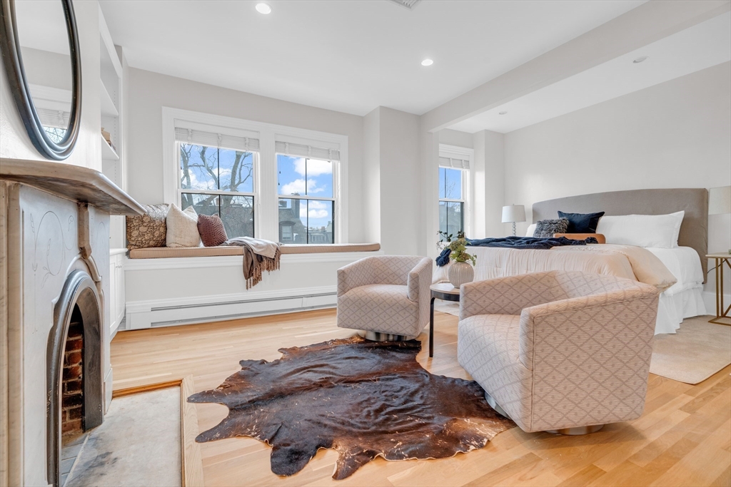 69 Rutland Street, Unit 3 Boston, MA 02118 - Photo 23 of 39 a living room with furniture a large window and a chandelier