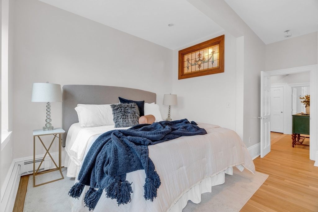 69 Rutland Street, Unit 3 Boston, MA 02118 - Photo 26 of 39 a bedroom with a bed and wooden floor