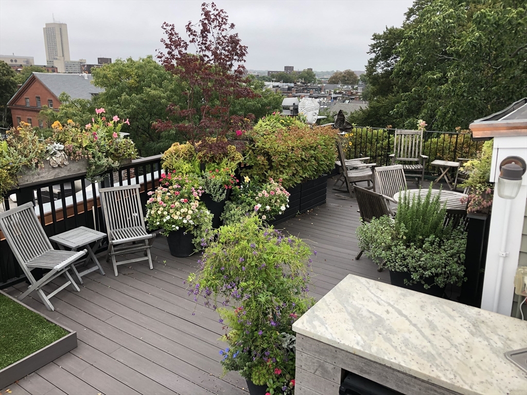 69 Rutland Street, Unit 3 Boston, MA 02118 - Photo 39 of 39 a view of a chairs and table on the wooden deck