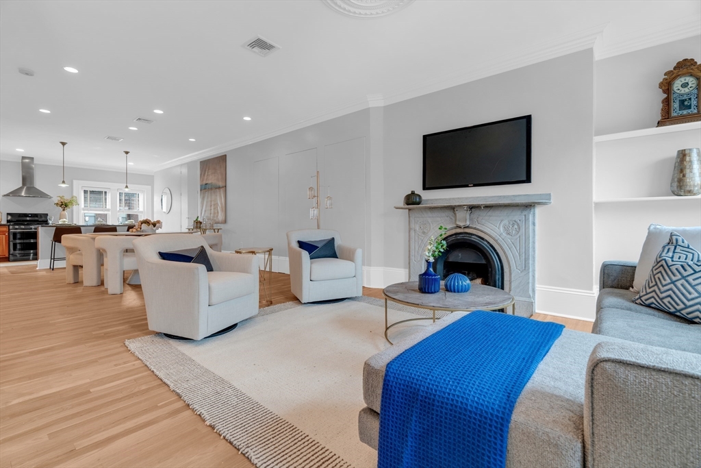 69 Rutland Street, Unit 3 Boston, MA 02118 - Photo 6 of 39 a living room with furniture a flat screen tv and a fireplace