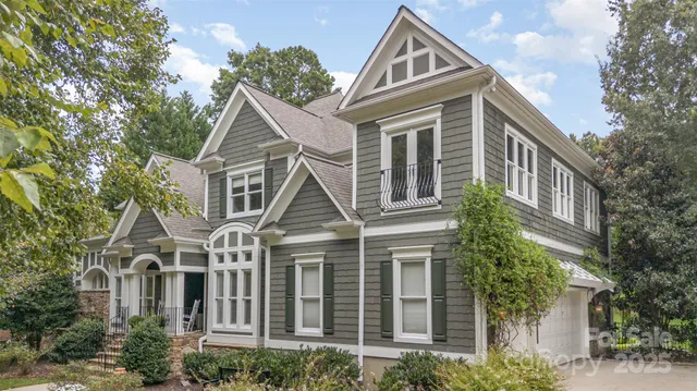 a front view of a house with a yard and potted plants