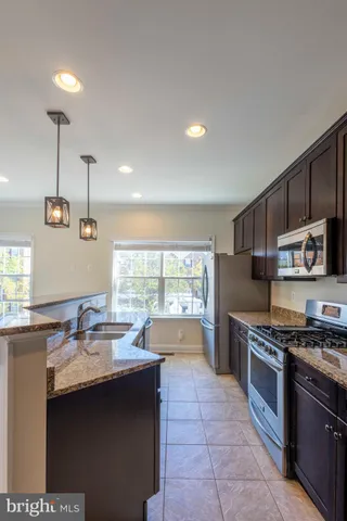 a kitchen with stainless steel appliances granite countertop a sink and cabinets