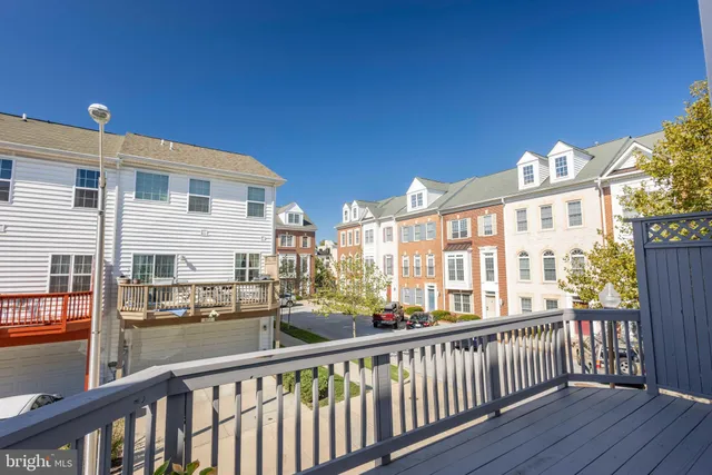 a view of entryway with wooden floor and fence and a floor to ceiling window