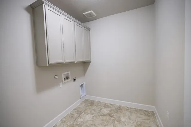 a room with a sink and cabinets