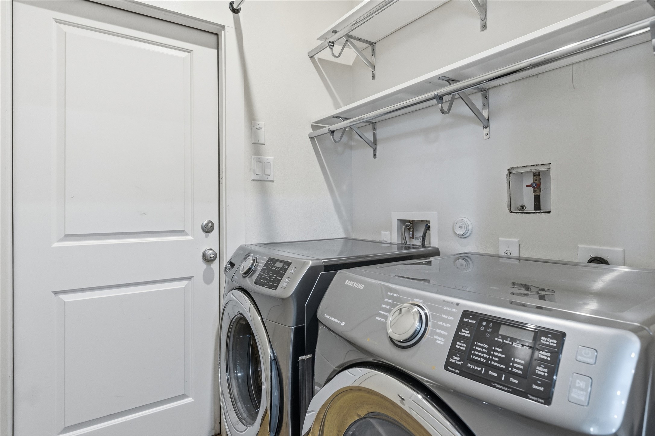 4124 Valley View Road, Unit 4A & 4B Austin, TX 78704 - Photo 10 of 40 A well-organized laundry area offers practical shelving and modern appliances for efficient home management.