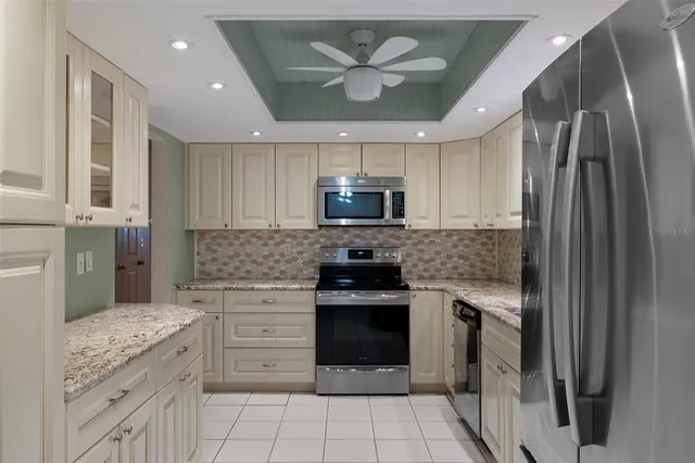 a kitchen with a stove sink and refrigerator