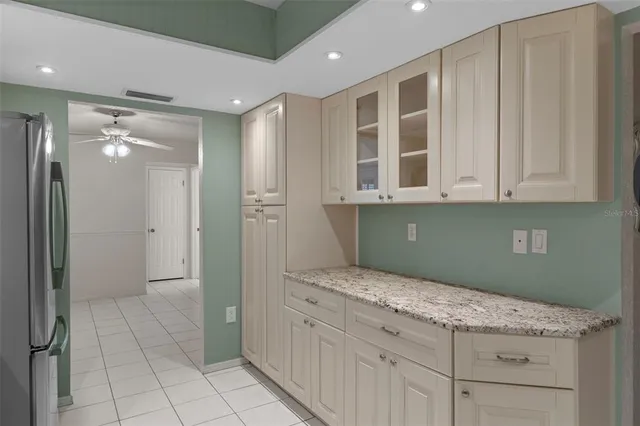 a kitchen with granite countertop a sink and cabinets